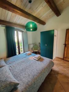 a bedroom with a large bed and a green cabinet at Rustico del Bozzo in Castelleone di Suasa