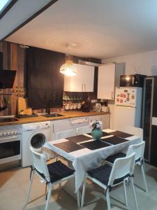 a kitchen with a table and chairs and a sink at CASA DE SILVA in Valladolid +12 photos
