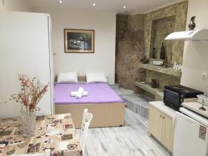 a small room with a bed and a table at Agnes Rooms in Pelekas