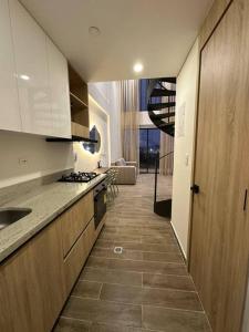 a kitchen with white cabinets and a tile floor at Apartamento Duplex Centro Histórico in Cartagena de Indias