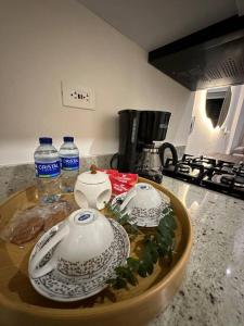 two tea sets on a tray on a kitchen counter at Apartamento Duplex Centro Histórico in Cartagena de Indias