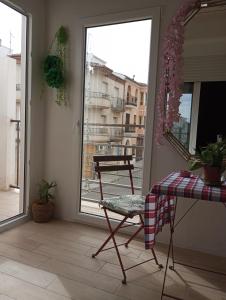 a room with a table and a chair on a balcony at Casa suig in Baena