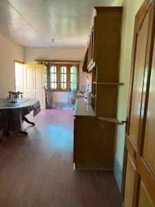 an empty room with a kitchen and a dining table at Shangrilla House Murree, Bhurban in Murree