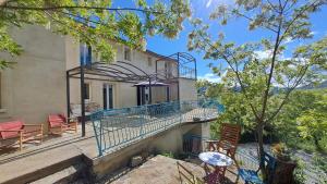 a balcony of a building with chairs and tables at La bergerie d'Annie in Privas