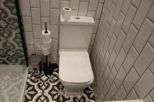 a bathroom with a white toilet in a room at RB in Stockport