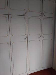 a bunch of white garage doors on a wall at Double room with ensuite shower room in quiet, private house in Worthing
