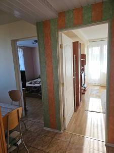 a room with colorful stripes on the walls at Jaukus butas Palangoje arti jūros in Palanga
