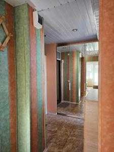 an empty room with colorful walls and a glass door at Jaukus butas Palangoje arti jūros in Palanga
