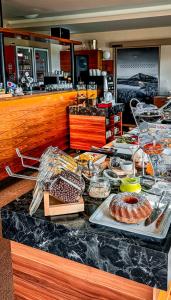 a buffet of food on a counter in a restaurant at Hotel Děvín in Pec pod Sněžkou