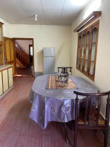 a dining room table with a purple table cloth on it at Shangrilla House Murree, Bhurban in Murree