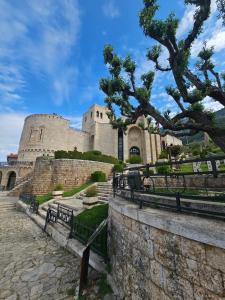 a castle with benches and a stone wall at Castle - inside,Voga Guesthause in Krujë