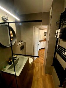 uma casa de banho com um WC branco e um espelho. em Central Nest Apartment em Brasov