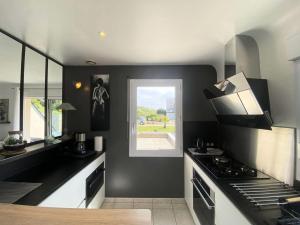 a kitchen with a stove and a window at Résidence S08-tregastel - Maison avec jardin privé près de la mer MAE-4614 in Trégastel +5 photos