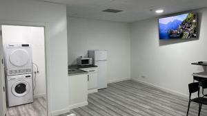 a laundry room with a washing machine and a microwave at O Albergue de Fene in Fene