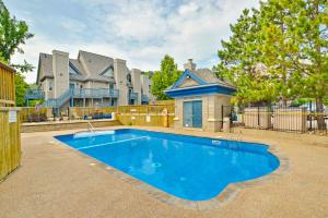 a large blue swimming pool in front of a house at Condo 214 at North Creek Resort by Vacasa II in Blue Mountains