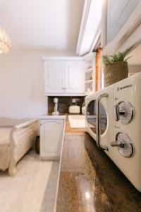 a kitchen with a washer and dryer in a room at Naxian Harmony Town Suites in Naxos Chora