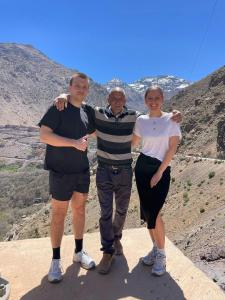 three people standing on top of a mountain at Dar Imoughlad in Marrakech