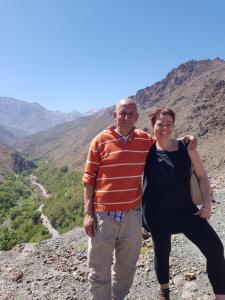 a man and a woman standing on top of a mountain at Dar Imoughlad in Marrakech