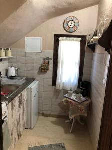 a small kitchen with a sink and a window at Talos House in Rakhónion