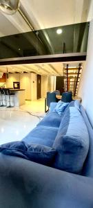 a large blue bed in a room with at White loft in Żyrardów