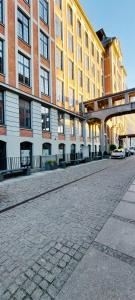 an empty street in front of a large building at White loft in Żyrardów +6 photos