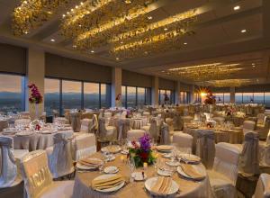 a large banquet hall with white tables and chairs at Grand Hyatt Denver in Denver