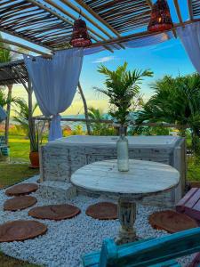 a table with a vase on it on a patio at Raio de Sol Residence in Canoa Quebrada