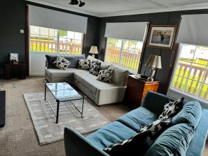 a living room with a couch and a table at Sunshine Lodge Haven Lakeland in Flookburgh