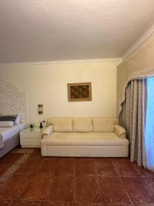 a living room with a couch and a bed at sharm prestige room 52 - luxury sea view at coral bay in Sharm El Sheikh