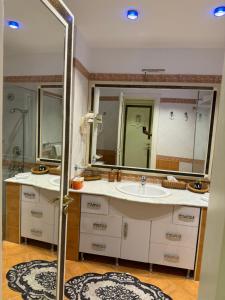 a bathroom with two sinks and a large mirror at sharm prestige room 52 - luxury sea view at coral bay in Sharm El Sheikh