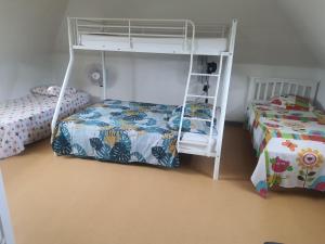 a bedroom with two beds and a bunk bed at Villa MARIE-GALANTE -Sainte-Anne in Sainte-Anne