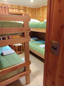 a room with four bunk beds in a cabin at Cabañas Privadas en Pucon in Pucón