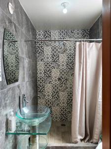 a bathroom with a glass sink and a shower at HOSTAL CHOCOLATE CALENDA in Oaxaca City +43 photos