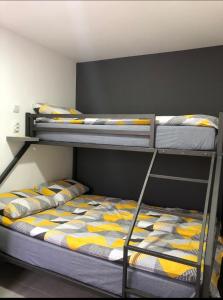 a bedroom with two bunk beds with yellow and blue at Aphrodite Hills Apartments-Stara Planina in Crni Vrh