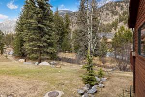 a view of a yard with trees and a house at Bugle Pointe A06 by Estes Park Condos in Estes Park