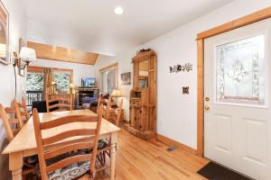 a dining room and living room with a table and chairs at Bugle Pointe A08 by Estes Park Condos in Estes Park