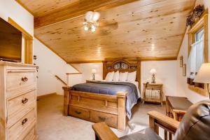 a bedroom with a bed and a wooden ceiling at Bugle Pointe A08 by Estes Park Condos in Estes Park