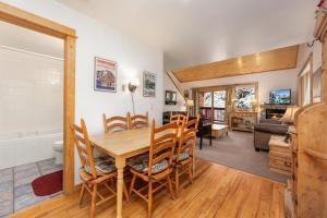 a dining room and living room with a table and chairs at Bugle Pointe A08 by Estes Park Condos in Estes Park