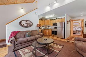 a living room with a couch and a table at Bugle Pointe A10 by Estes Park Condos in Estes Park