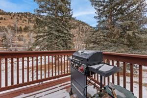 a grill on a deck with mountains in the background at Bugle Pointe A10 by Estes Park Condos in Estes Park +12 photos