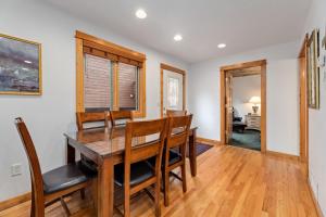 a dining room with a wooden table and chairs at Bugle Pointe A11 by Estes Park Condos in Estes Park
