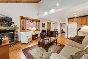 a living room with a couch and a fireplace at Bugle Pointe A11 by Estes Park Condos in Estes Park