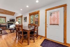 a dining room and living room with a table and chairs at Bugle Pointe A11 by Estes Park Condos in Estes Park