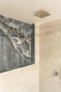 a bathroom with a marble wall at NEON 2BR Luxurious Central Apt Heraklion in Heraklio Town