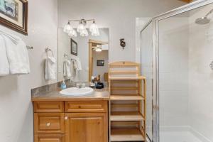 a bathroom with a sink and a shower at Bugle Pointe A12 by Estes Park Condos in Estes Park