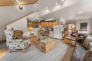 a living room with a couch and chairs and a kitchen at Bugle Pointe A12 by Estes Park Condos in Estes Park +12 photos