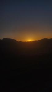a view of the sun setting over the mountains at Waid Rum Jordan Jordan in Wadi Rum