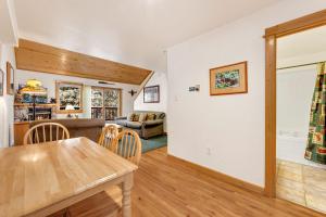 a dining room and living room with a table at Bugle Pointe A14 by Estes Park Condos in Estes Park +11 photos
