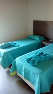 Ένα ή περισσότερα κρεβάτια σε δωμάτιο στο APART HOTEL BELGRANO en CAÑUELAS