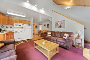 a living room with a couch and a table at Bugle Pointe A15 by Estes Park Condos in Estes Park